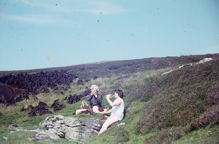 Work involved families and neighbours spending long days on the moors, turning and heaping the peats. It is hot work for Teenie Leslie and Winnie Leask at Tingwall, and the hot lemonade never was so welcome!